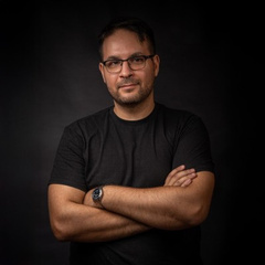 Portrait of Ilko Masaldzhiyski, arms crossed, black t-shirt