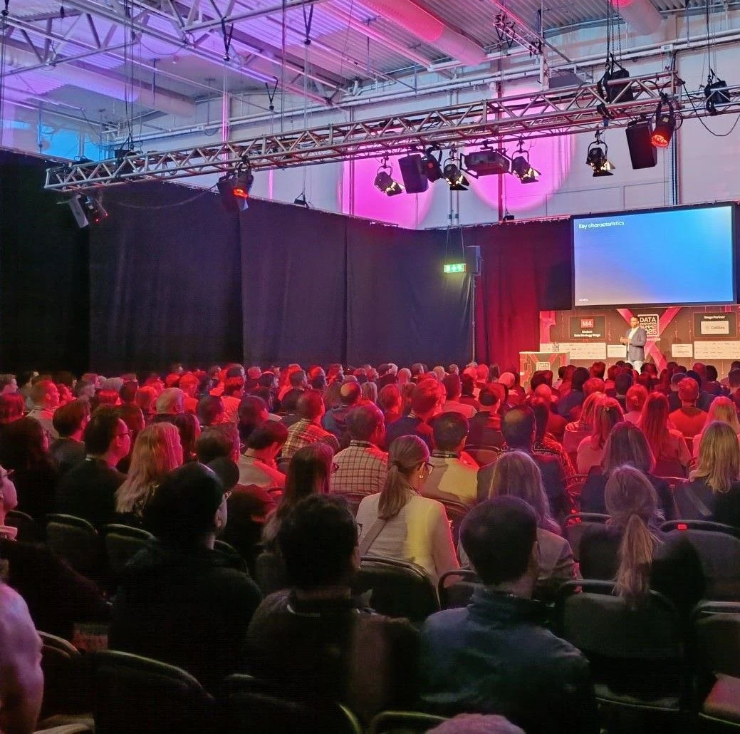A full room on the M4 stage at Data Innovation Summit 2025, Ilko presenting at the far end